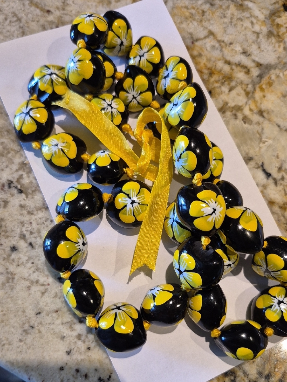 Hawaiian painted kukui nut lei, a traditional garlandmade frompolished candlenut
